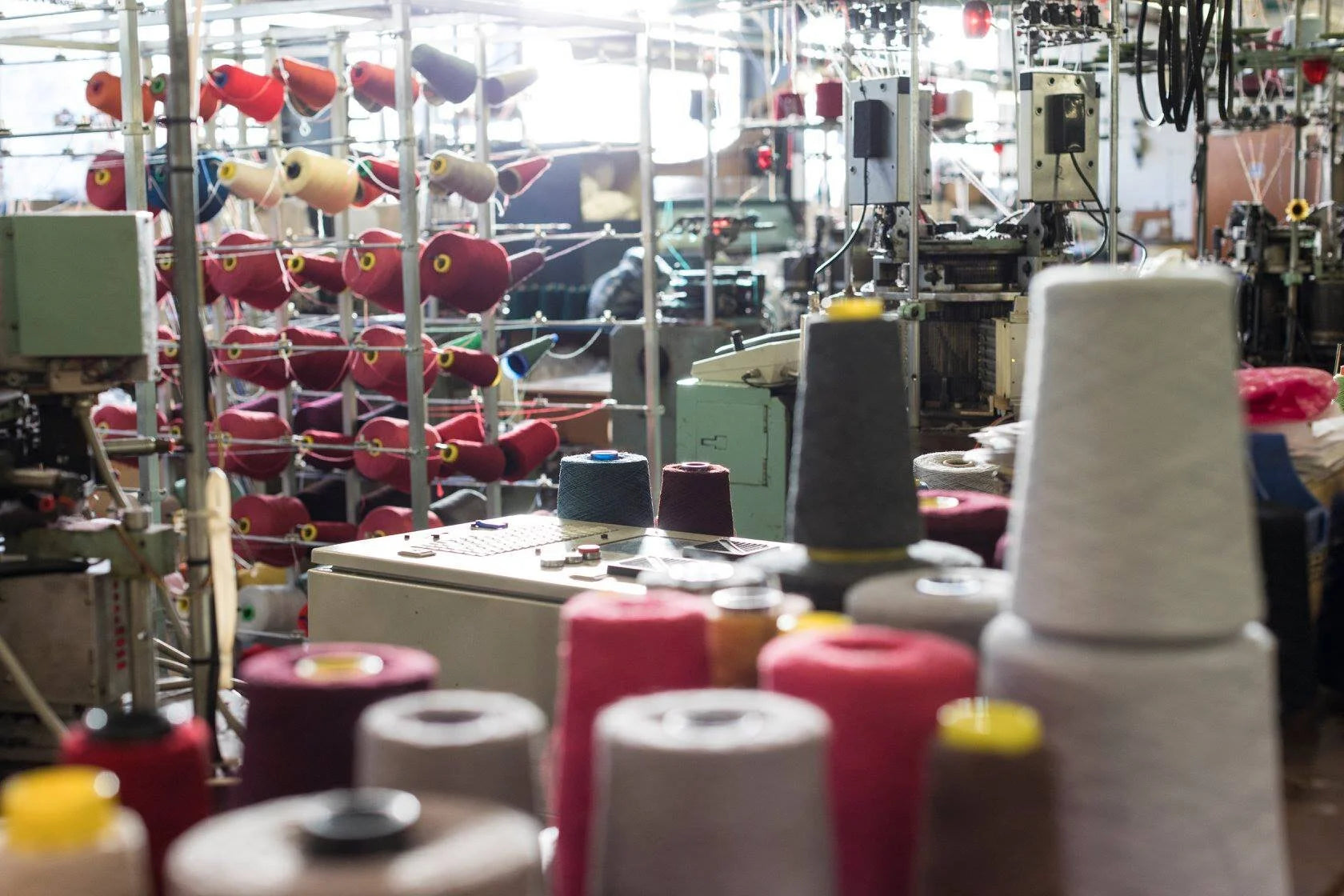 Spools of colorful thread in a textile factory setting
